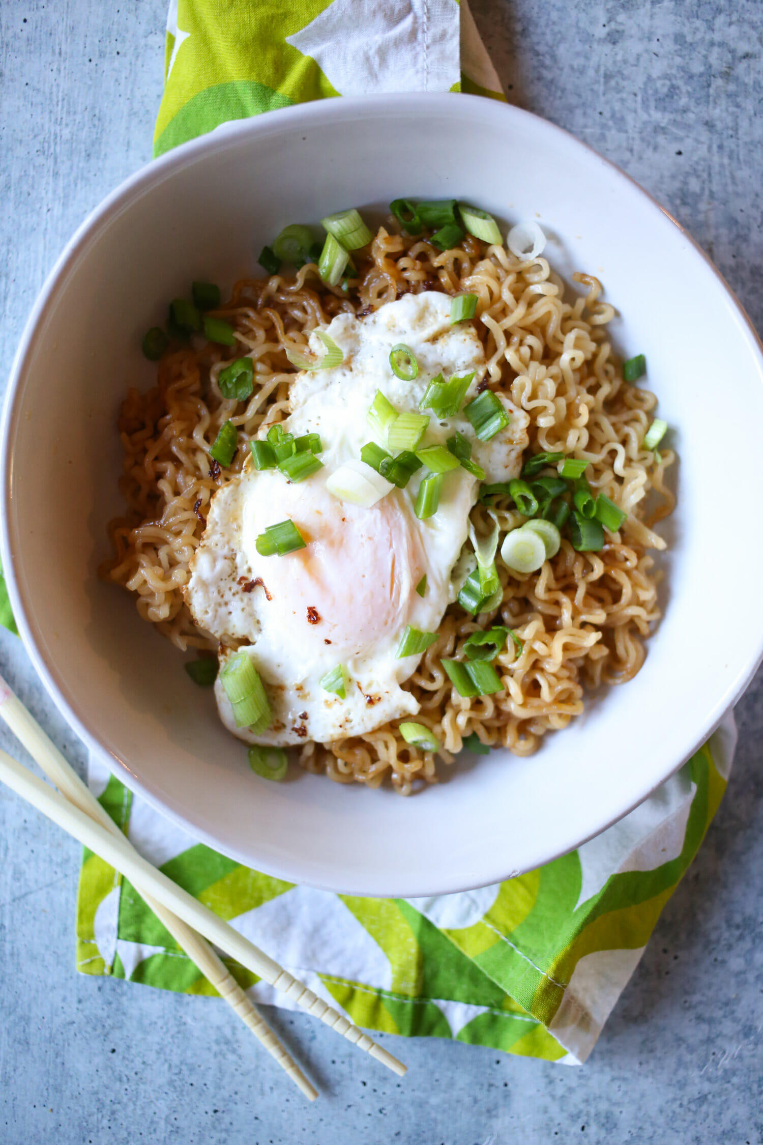 fried egg and sliced green onions on top of Ramen noodles