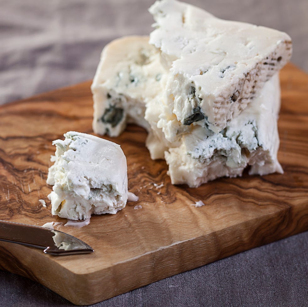 pieces of gorgonzola cheese on chopping board