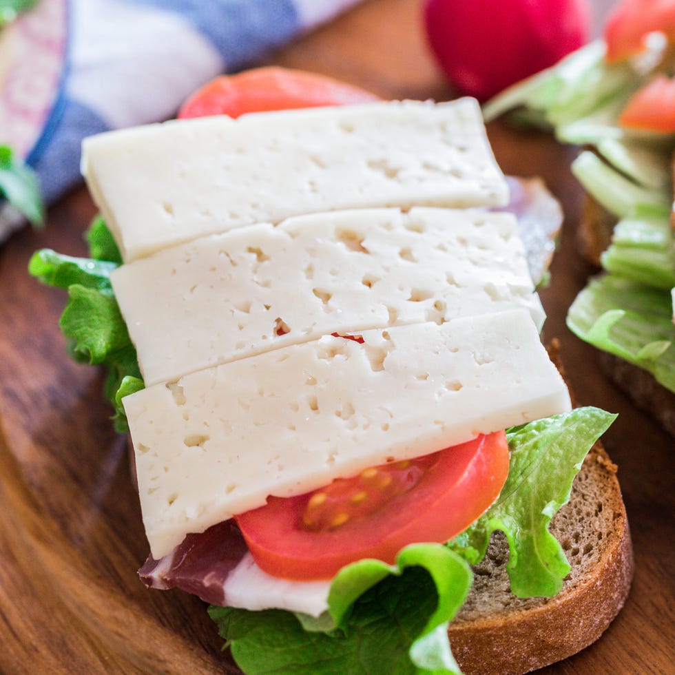 breakfast on table, sandwiches with pancetta, havarti cheese and veggies on table