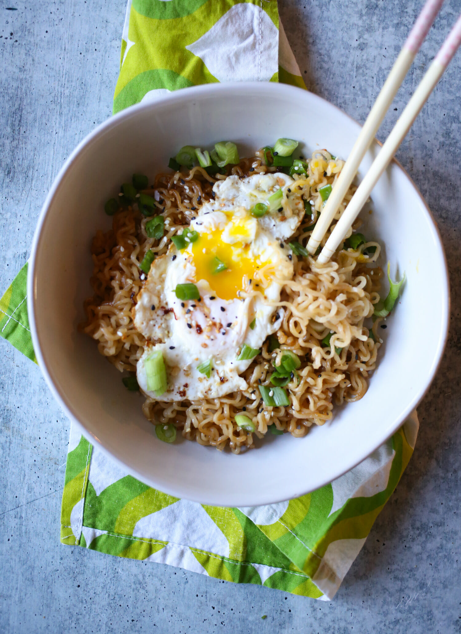 Fried egg over ramen noodles with chopsticks